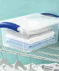 Pack Of Three 7 Quart Clear Plastic Storage Bins Featuring Heavy Duty Walls And Foolproof Snap Lock Lids To Keep Garage Or Desk Clutter Totally Under Control For Busy Mornings with stacked towels.