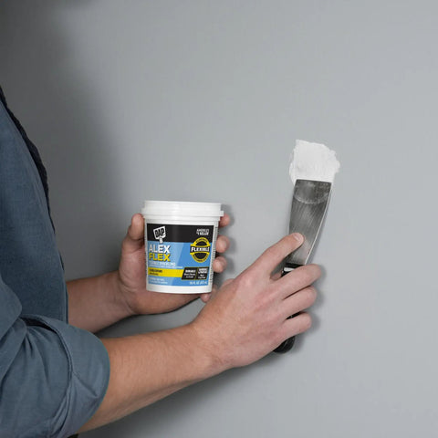 Person using Alex Flex Flexible Spackling White 16 Oz Won’t Sink Shrink Or Crack Sandable And Paintable For Interior And Exterior Use