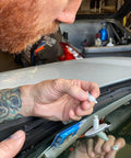 Person using Bullseye Windshield Repair Kit With 0.025 Oz Syringe For Quick, No Mixing One-Component Fix That Cures In Sunlight Up To 1 1/4 Inches On Laminated Auto Glass Great For DIY Repairs With Fast Cure And Minimal Mess on car windshield