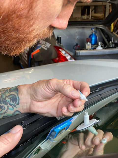 Person using Bullseye Windshield Repair Kit With 0.025 Oz Syringe For Quick, No Mixing One-Component Fix That Cures In Sunlight Up To 1 1/4 Inches On Laminated Auto Glass Great For DIY Repairs With Fast Cure And Minimal Mess on car windshield