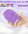 Hand holding purple skein from Ultimate Beginner Crochet Kit For Adults With 9 Soft-Handle Hooks, 20 Skeins Yarn, Handy Crochet Bag