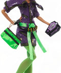 Clawdeen Wolf Dawn Of The Dance Reproduction Doll with vibrant green hair, purple zip dress and accessories, striking a stylish pose.