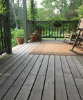 Ranchworn Aging Wood Stain Quick Turnaround Formula Dries In Half Hour applied to a wooden deck with potted plants and chairs.