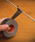 Mini Duct Tape To Go 1 Inch By 10 Yards Black Travel Size Pack Of 6 being used to fix a rod with heavy duty adhesive