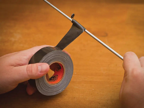 Mini Duct Tape To Go 1 Inch By 10 Yards Black Travel Size Pack Of 6 being used to fix a rod with heavy duty adhesive