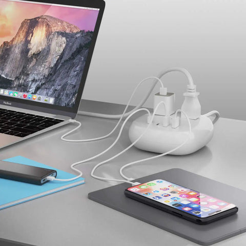 65W USB Power Strip With Surge Protection connected to devices on desk showing multiple charging via USB and power outlets