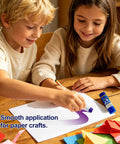 Children using 12 Count 6g Glue Sticks, Purple Goes On Then Dries Clear, All Purpose Adhesive for crafts on a desk