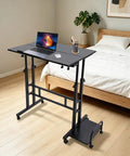 Smooth Operator Height Adjustable Standing Desk With Heavy Duty Steel Build And Six Easy Roll Wheels in a home office setup.