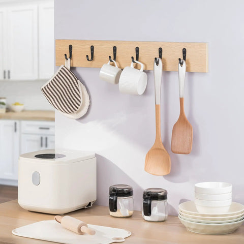 10 Pack Wall Hooks For Bathroom Kitchen Closet And Garage Black Metal Hangers That Hold Up To 40 Lbs Ultra Strong Built To Last installed on wall holding kitchen items like cups, towel, and utensils.