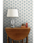 Sick Periwinkle Matte Wallpaper With Subtle Linen Texture showcased behind a wooden table and lamp, perfect for indoor decor.