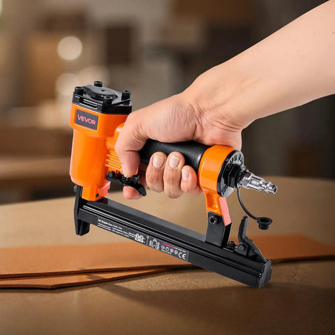 Pro Grade Pneumatic Staple Gun For Woodworking And Upholstering Projects Featuring Slick Firing 22 Gauge Design in hand on workspace.