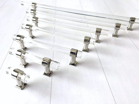 Set of clear chrome finish Lucite acrylic cabinet pulls in various sizes on white background