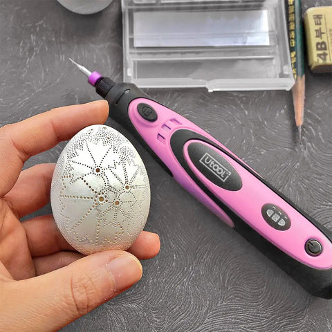 Pink 4V Cordless Rotary Tool Kit With 42 Accessories for DIY Crafts shown with an engraved egg for detail work