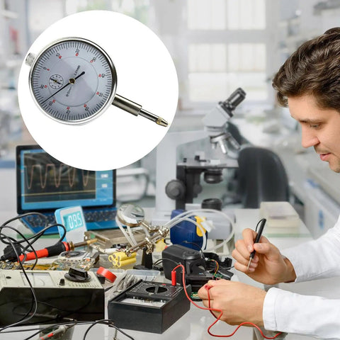 Dial Indicator Gauge With Clear Scale For Precise Measurements in Machining, shown in a lab with electronic tools and equipment.