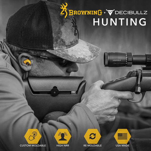 Man wearing Decibullz Custom Molded Earplugs for Shooting with 31 Decibels NRR aiming rifle at shooting range.