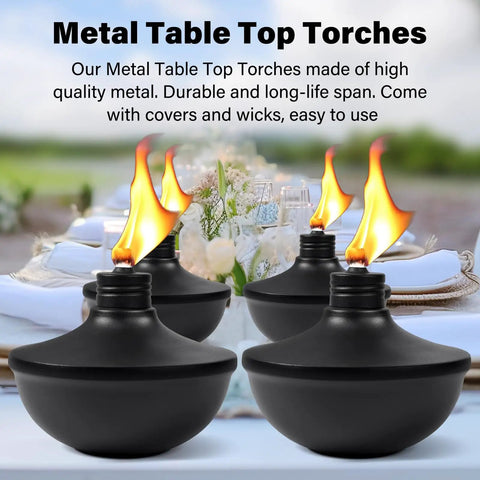 Four black metal tabletop torches lit on a table, part of Six Pack Upgraded Tabletop Citronella Torches With 24 Oz Fuel Capacity Refillable Outdoor Torch Lights Includes Wicks Covers And Funnel Party Ready For Garden Patio Deck Yard And Landscape set.