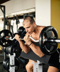Man using Preacher Curl Bench Adjustable Arm Curl Bench For Bicep Isolation Home Gym Strength Training with barbell