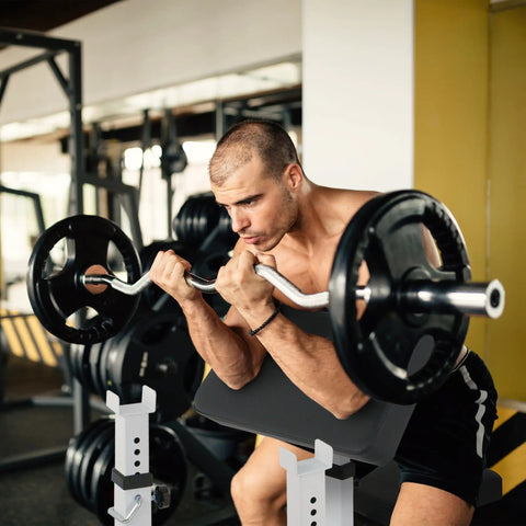 Man using Preacher Curl Bench Adjustable Arm Curl Bench For Bicep Isolation Home Gym Strength Training with barbell
