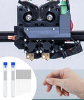 Hand using Essential 50 Piece 3D Printer Nozzle Cleaning Kit With 0.2mm 0.25mm 0.3mm 0.35mm 0.4mm stainless needles for maintenance