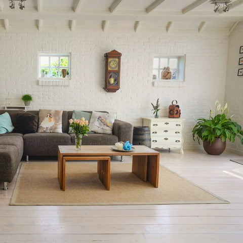 Bright living room with modern decor, including a brown sectional sofa and wooden coffee table on a beige rug.