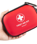 Front view: Mini red waterproof hard-shell first aid kit with carabiner, 120-piece supplies