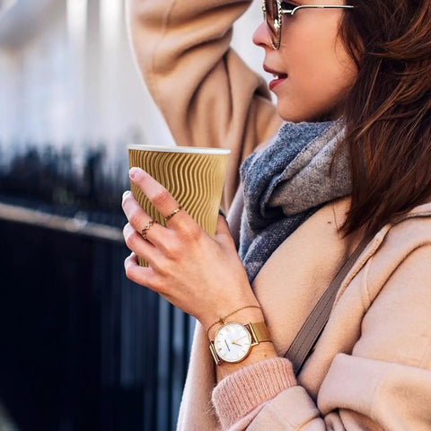 Woman holding No Sleeve Needed 12 Oz Ripple Wall Corrugated Insulated Paper Cup With Anti Scald Grip