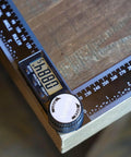 Digital Angle Finder Protractor 7 Inch 200mm Angle Gauge for carpentry on wood surface with LCD showing angle measurement