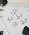 Heavy Duty Steel Shelf Clips For Metal Cabinets And Display Units Easy To Use Lightweight Shelf Supports With Simple Structure Ideal For Bookcases And File Cabinets Ten Pack arranged on a table