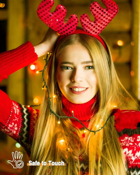Woman wearing red antler headband with 2Pack 500LED Solar String Lights Outdoor Waterproof 180FT With 8 Modes IP65 Warm White Twinkle