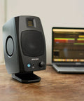 D3V Active Desktop Monitoring System Pair With USB C Connection in sleek black finish next to laptop on wooden desk.