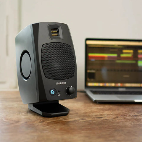 D3V Active Desktop Monitoring System Pair With USB C Connection in sleek black finish next to laptop on wooden desk.