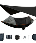 All In One Camping Hammock With Mosquito Net And Rain Fly Tarp set, portable double tree hammock with accessories displayed outdoors