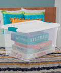Super Tight Fit 64 Quart Clear Plastic Storage Bins 72 Pack With Snappy Hinged Lids on bed storing board games.