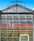 10 Inch Wall Mounted Exhaust Fan With Automatic Shutter And Variable Speed For Attic Shed Or Garage Ventilation 820 CFM 1200 Sq Ft Coverage No Brainer Energy Saving Cooling Ready To Install Cord Not Included in a greenhouse setting with remote control visible.