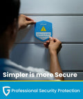 Person installing video and audio surveillance sign, emphasizing security with 'Simpler is more Secure' slogan.