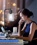 Two Pack Fully Stepless Dimmable Industrial Table Lamps With USB Ports And AC Outlet Seeded Glass Bedside Desk Lamps next to a woman working