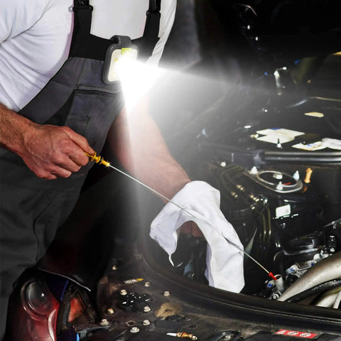 Mechanic using Two Pack Go To Night Run Lights For Runners, Ultra Bright LED And COB Spotlight with sturdy clip while fixing engine