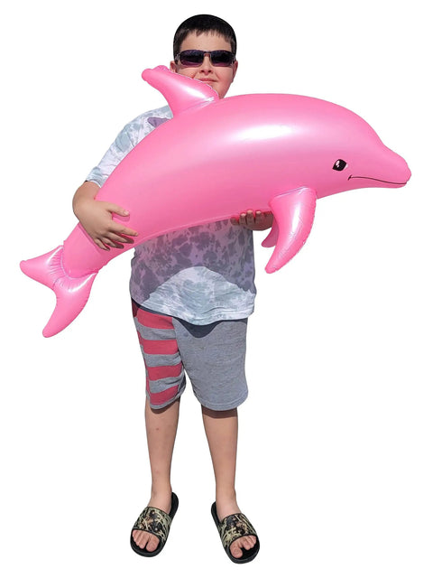 Person holding a Massive 40 Inch Pearlized Dolphin Inflatable Pool Toy for Beach and Poolside Fun Pink 3 Pack Centerpiece Decor