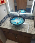 Bathroom vanity with Dope Teal Blue Crystal Glass And Gray Marble Mosaic Tile interlocking sheets backsplash, stone countertop.