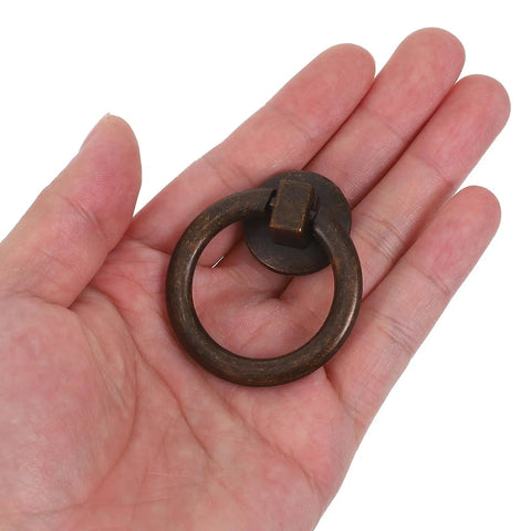Hand holding one piece of Two Pack Vintage Drop Ring Drawer Pulls In Antique Bronze For Dresser Cabinets And Doors Retro Cabinet Knobs And Handles For Classic Furniture Hardware