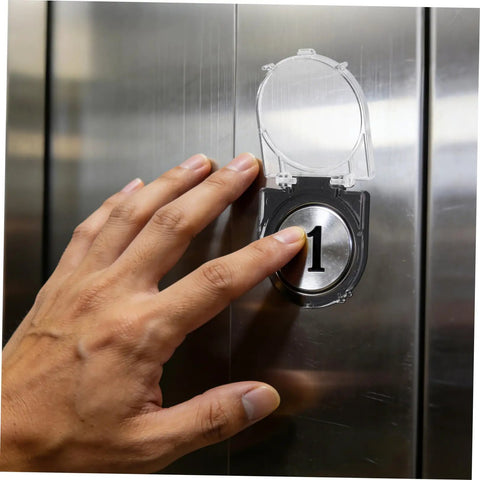 Heavy Duty Elevator Button Protective Cover And Switch Guard for Industrial Pushbuttons shown shielding button from dust in elevator.
