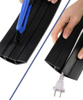Black 10 Foot Floor Cord Cover With Large Cable Channels being cut and installed with cable inside.