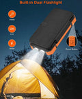 Massive 49800mAh Solar Power Bank With Four Built In Cables And Four Foldable Panels PD 22W Fast Charge USB C Input And Output Flashlight illuminating a tent