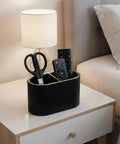 Black PU Leather Desk Organizer Pen Holder With Dual Compartment Pencil Cup And Remote Control Storage on bedside table.