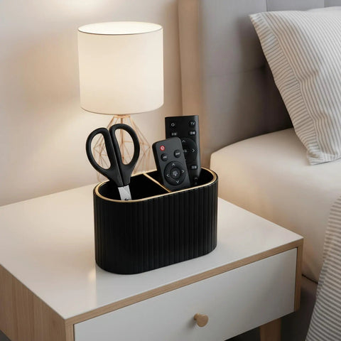 Black PU Leather Desk Organizer Pen Holder With Dual Compartment Pencil Cup And Remote Control Storage on bedside table.