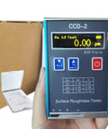 Digital Roughness Tester Profilometer For Metal And Non Metal Surfaces With Evaluation Lengths 1.25 4.0 5.0 Millimeters Ra Rq 0.05 To 15.0 Micrometers Rz Rt 0.1 To 50.0 Micrometers USB Charging Display Workhorse Tool held in hand showing digital display with packaging in background.