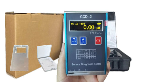 Digital Roughness Tester Profilometer For Metal And Non Metal Surfaces With Evaluation Lengths 1.25 4.0 5.0 Millimeters Ra Rq 0.05 To 15.0 Micrometers Rz Rt 0.1 To 50.0 Micrometers USB Charging Display Workhorse Tool held in hand showing digital display with packaging in background.