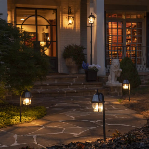 Pathway lit with Black Solar Garden Light With Shepherd Hook, resin acrylic body and cast aluminum post, enhancing yard decor.