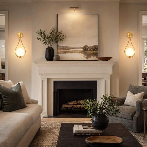 Lit Mid Century Modern Wall Sconces Set Of 2 With Globe Glass Shades In Antique Brass Finish in living room above fireplace.