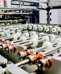Machine with Orange Round Polyurethane Belt 3mm Diameter, 10ft Length, used in drive transmission, visible on rollers